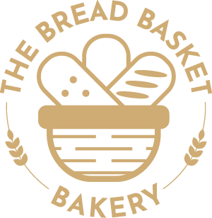 The Bread Basket Bakery logo - brown writing circled around a bread basket with three loaves in it